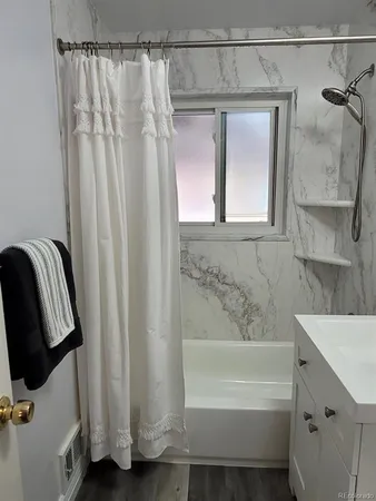 a bathroom with a bathtub and a shower