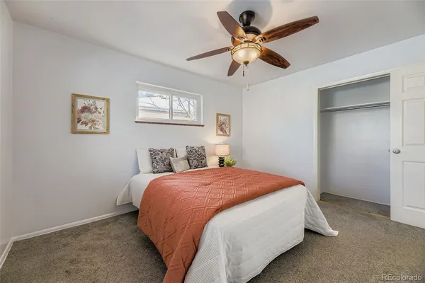 a bedroom with a bed and a ceiling fan