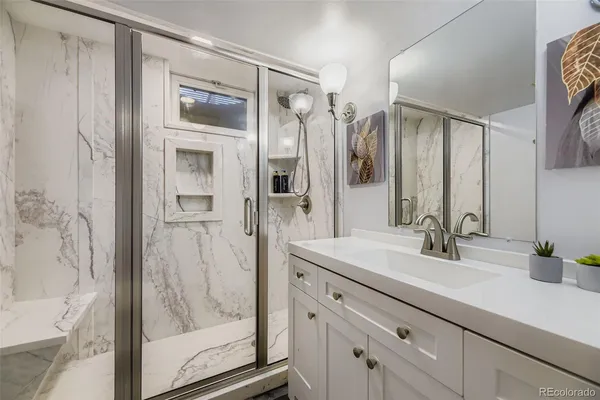 a bathroom with a shower sink and mirror