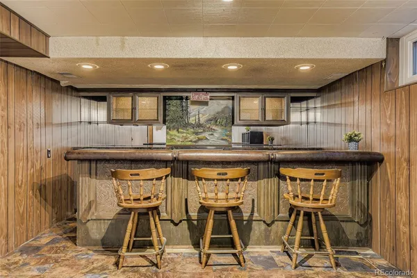 a kitchen with stainless steel appliances kitchen island granite countertop a stove and cabinets