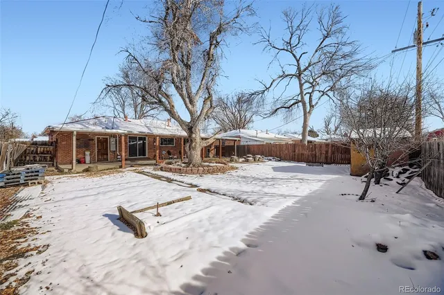a view of a roof covered with snow in the background