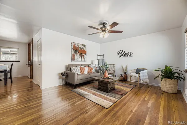 a living room with furniture and wooden floor