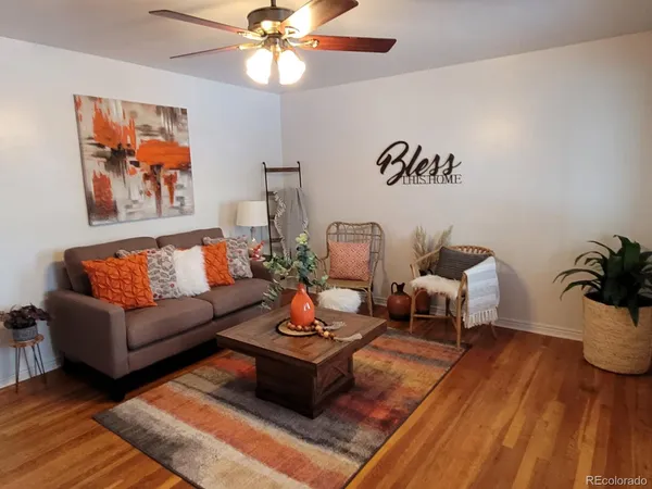 a living room with furniture and wooden floor