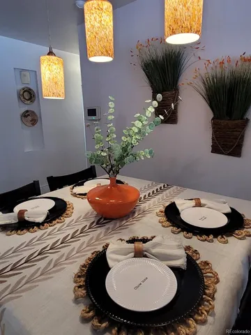 a table with chairs and a potted plant