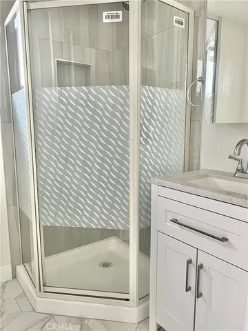 a bathroom with a shower and a sink