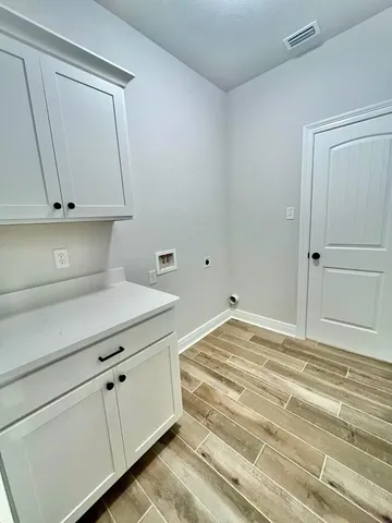 a view of a kitchen with white cabinets