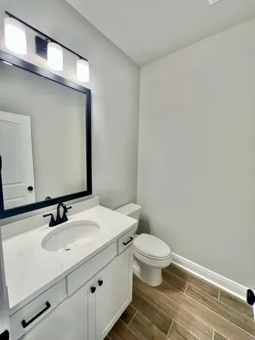 a bathroom with a sink a toilet and a mirror