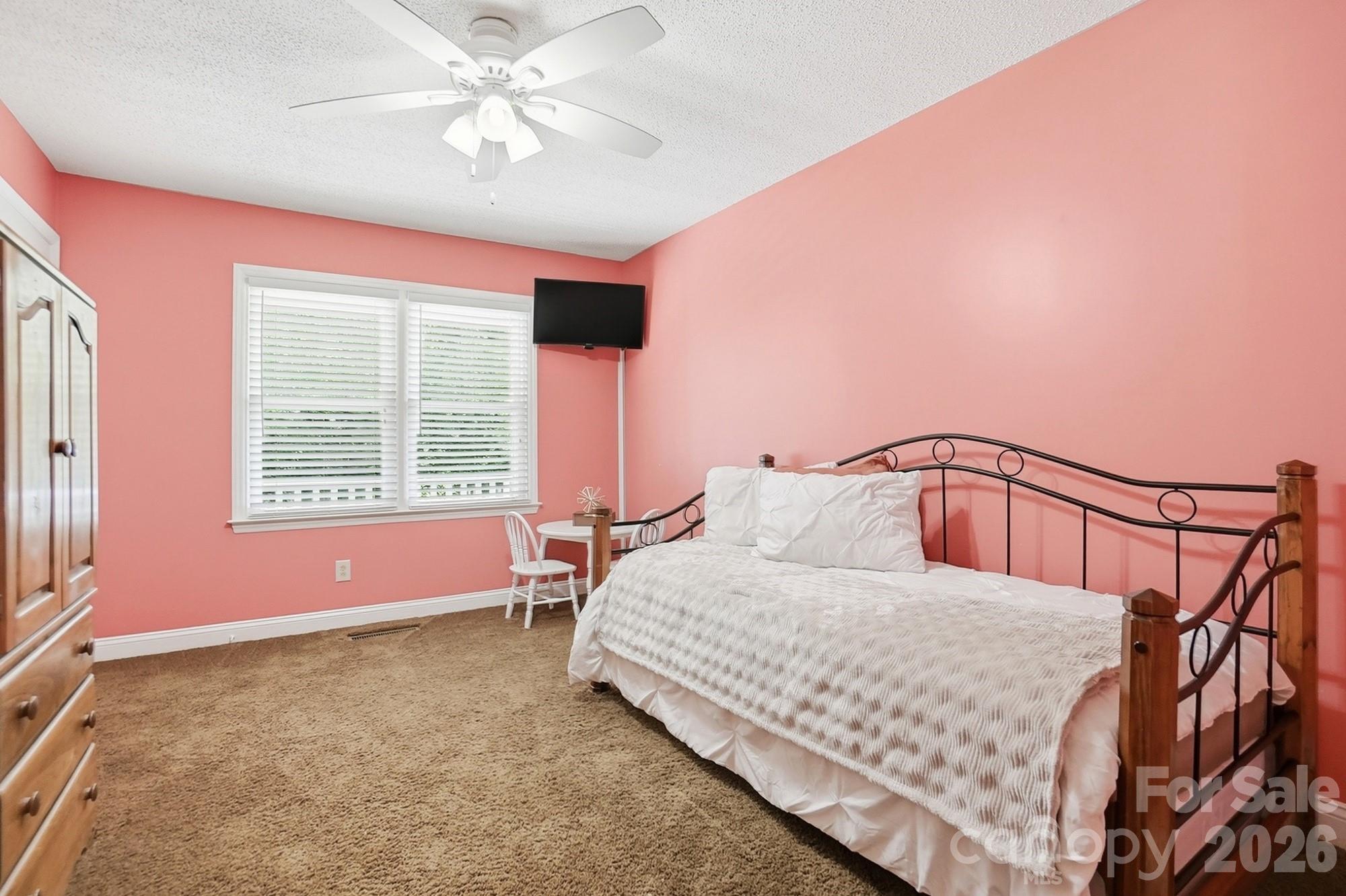 4017 Mullis Newsome Road Monroe, NC 28110 - Photo 28 of 38 a bedroom with a bed dresser and a window