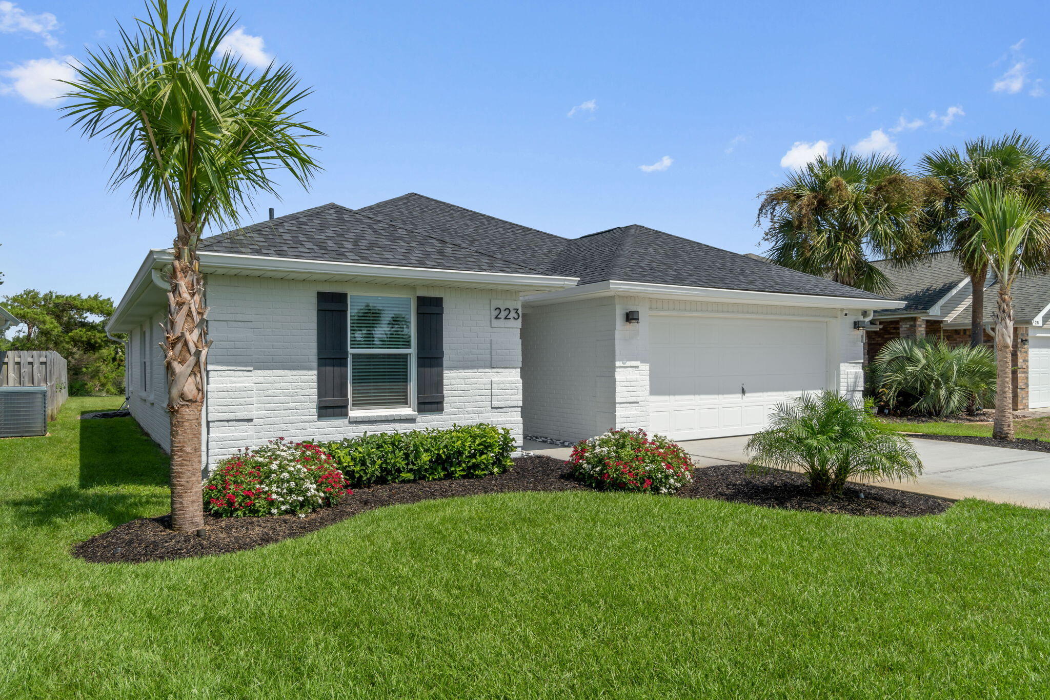 a front view of house with yard and green space
