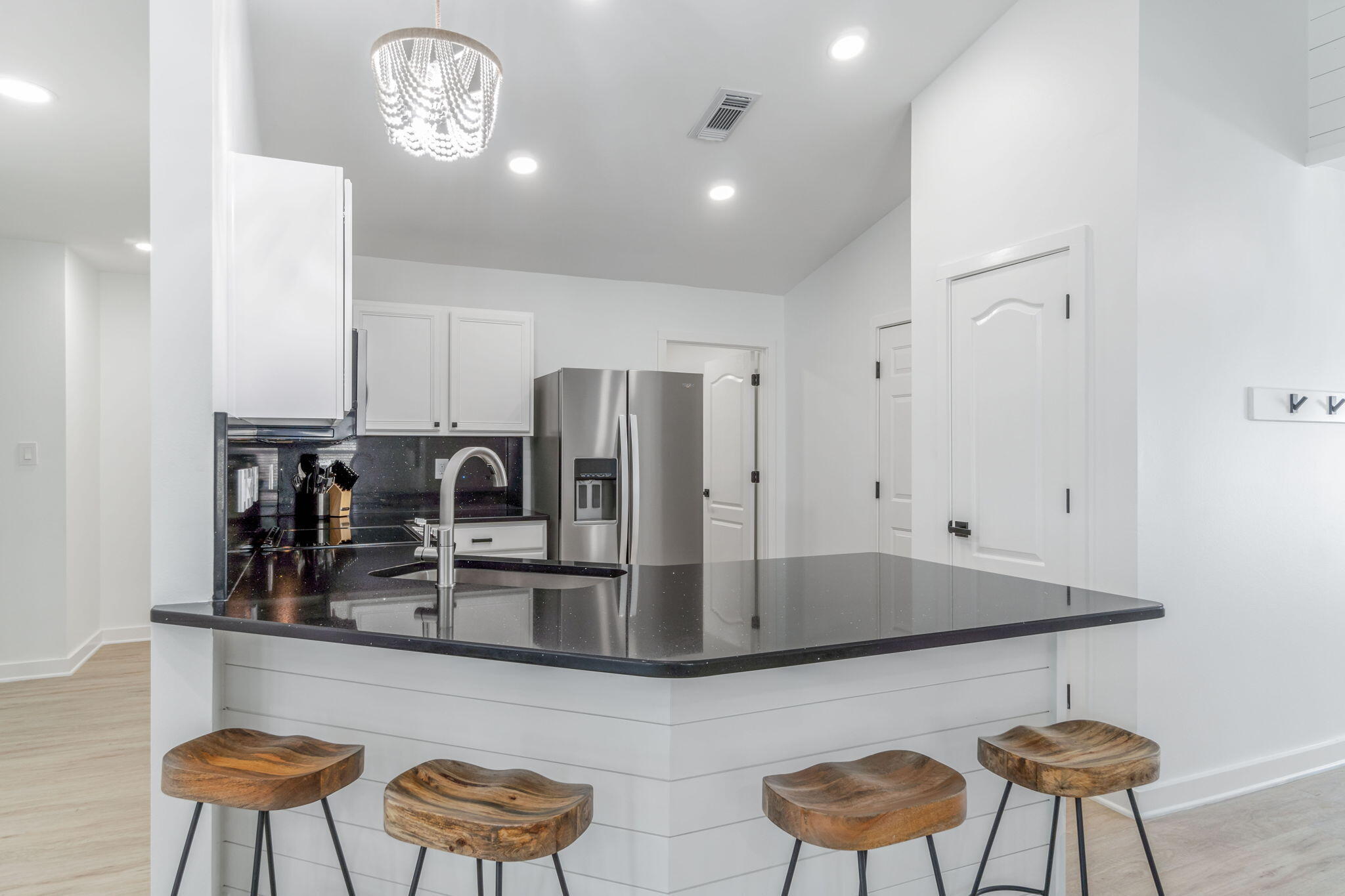 223 Sandy Cay Drive Miramar Beach, FL 32550 - Photo 39 of 79 a kitchen with stainless steel appliances kitchen island granite countertop a dining table chairs and a refrigerator