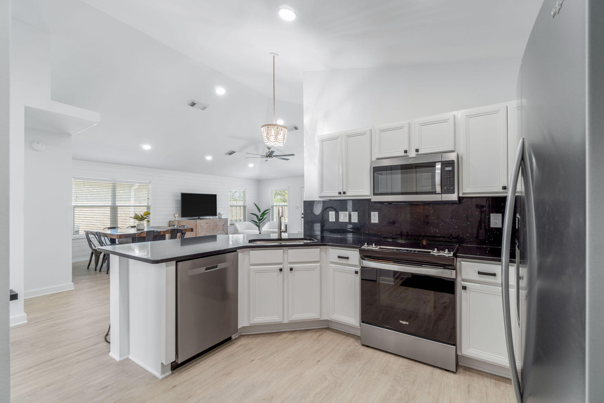 223 Sandy Cay Drive Miramar Beach, FL 32550 - Photo 40 of 79 a kitchen with stainless steel appliances a stove sink microwave and cabinets
