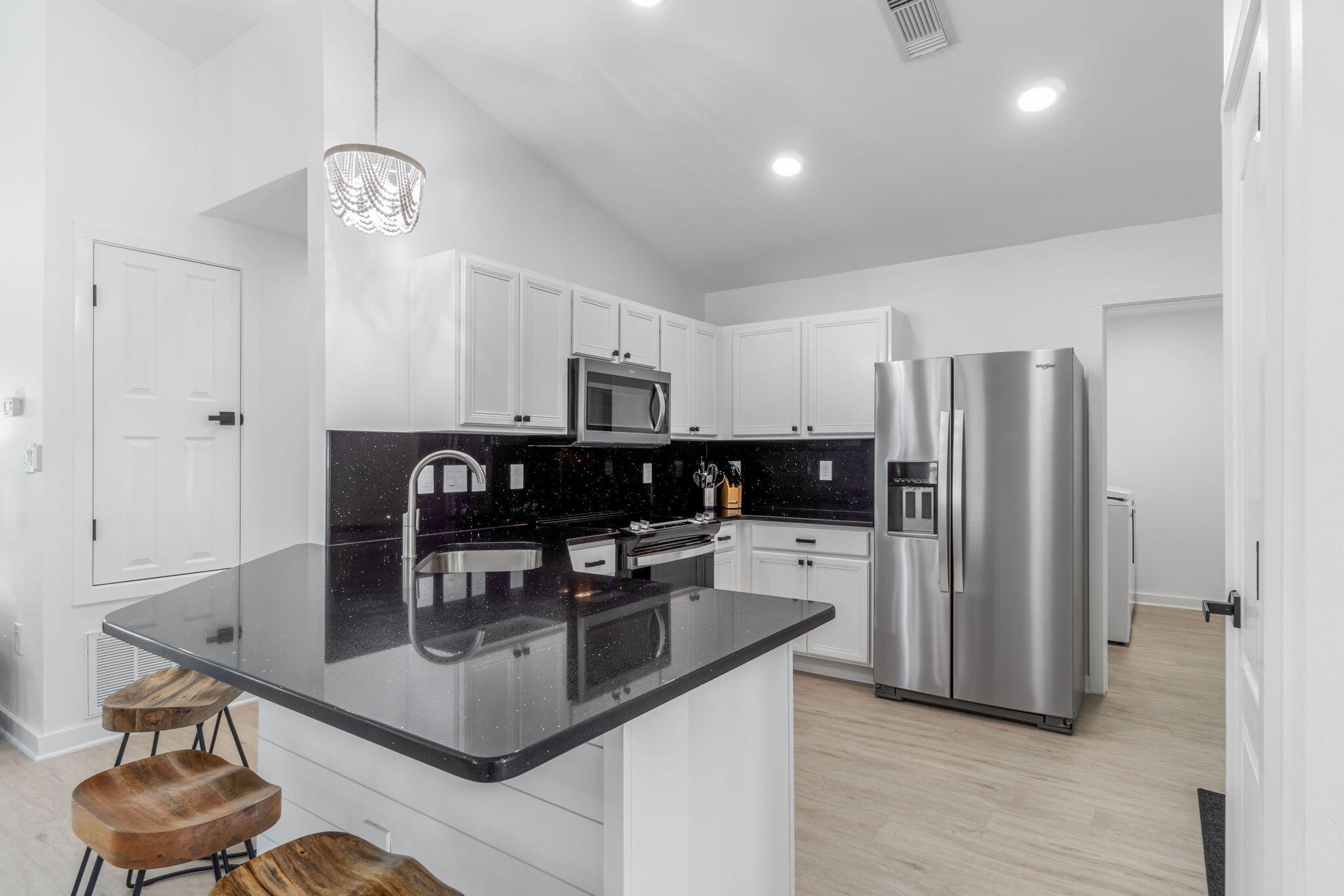 223 Sandy Cay Drive Miramar Beach, FL 32550 - Photo 41 of 79 a kitchen with stainless steel appliances granite countertop a table chairs and a refrigerator