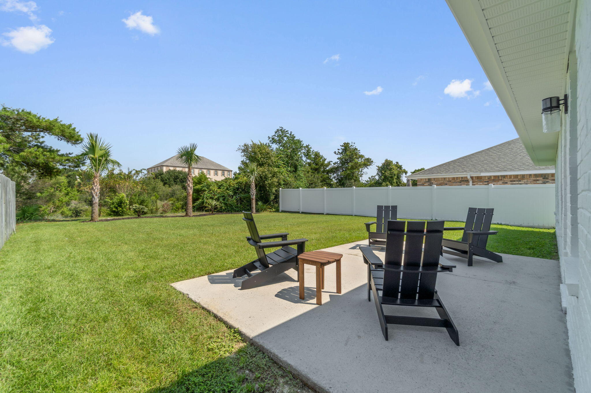223 Sandy Cay Drive Miramar Beach, FL 32550 - Photo 58 of 79 a view of a patio with table and chairs and a big yard