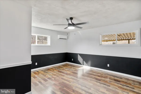 a bedroom with a bed and a ceiling fan