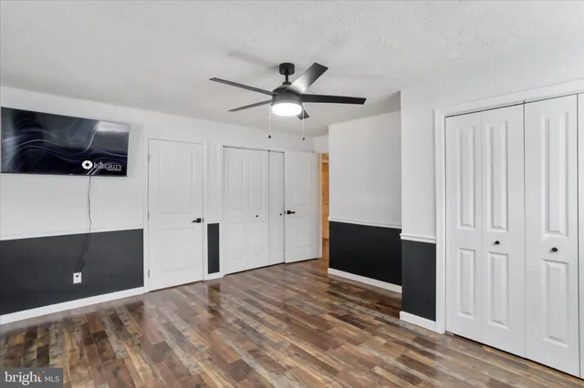a view of an empty room and kitchen