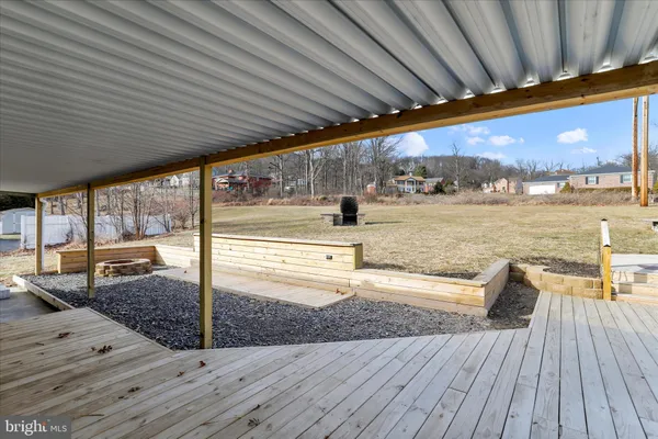 a view of a terrace with lawn chairs