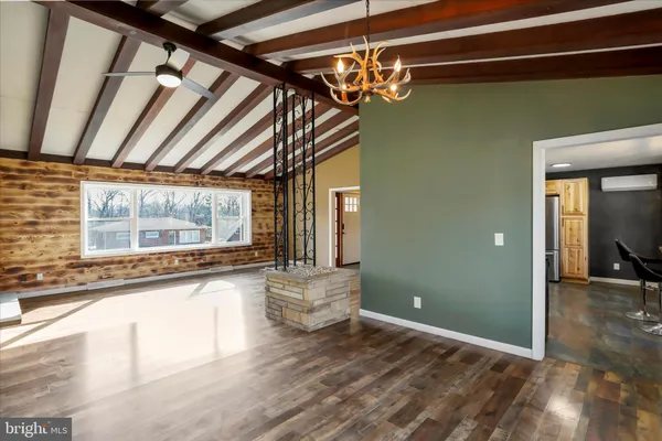 a view of a room with wooden floor and furniture
