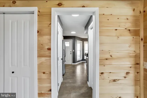 a view of a hallway with wooden shelves