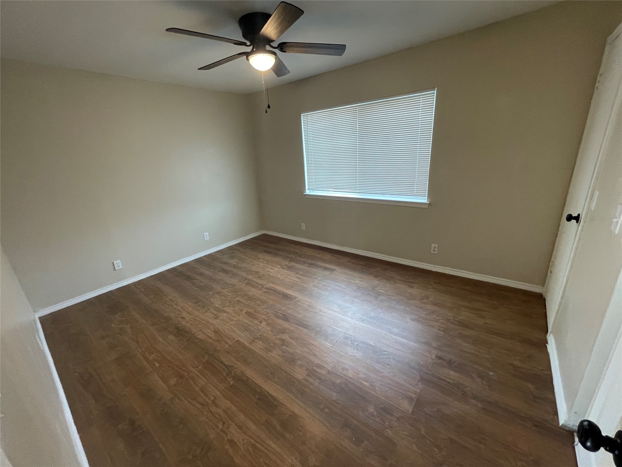 6253 Manor Road, Unit B Austin, TX 78723 - Photo 4 of 10 Master bedroom featuring dark wood-type flooring, ceiling fan, and 2 closets.