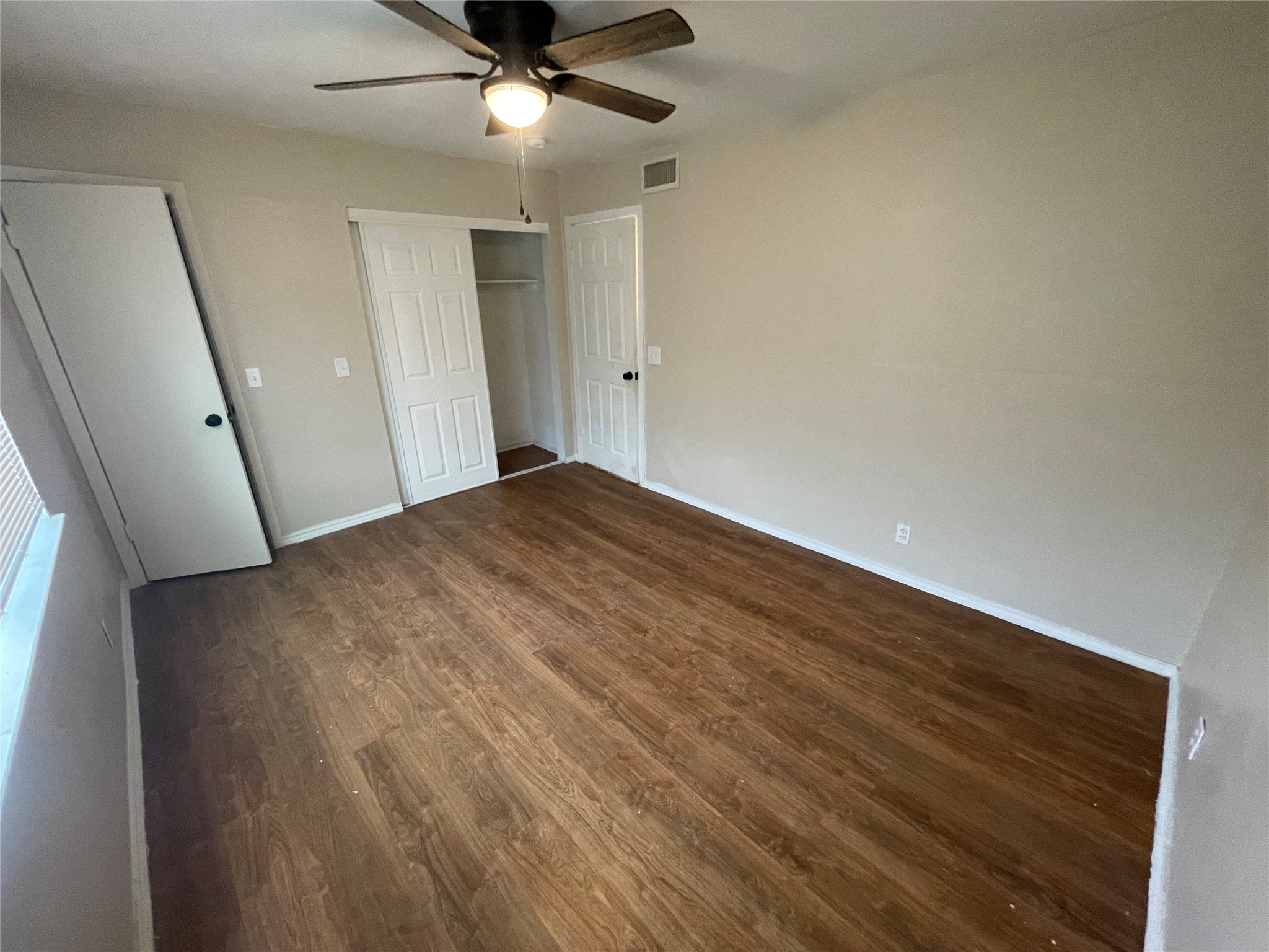 6253 Manor Road, Unit B Austin, TX 78723 - Photo 5 of 10 Master Bedroom with dark wood-type flooring, a closet, and a ceiling fan