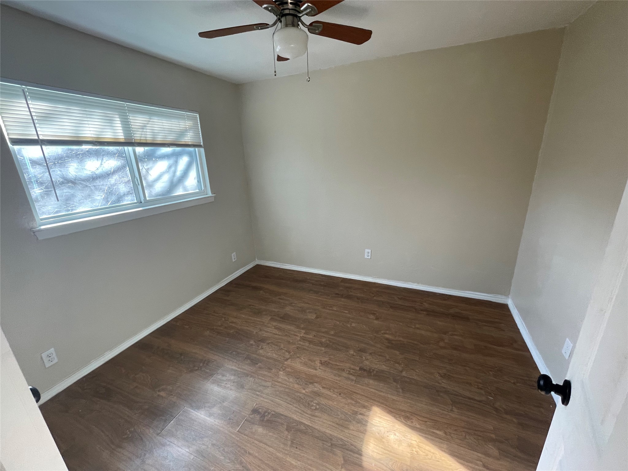 6253 Manor Road, Unit B Austin, TX 78723 - Photo 6 of 10 2nd bedroom with dark wood-style flooring and ceiling fan