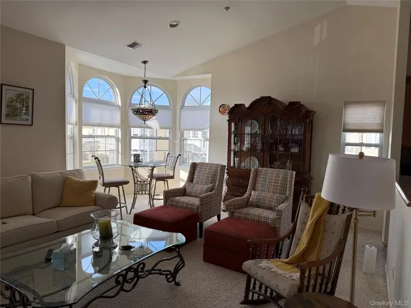 a living room with furniture and kitchen view