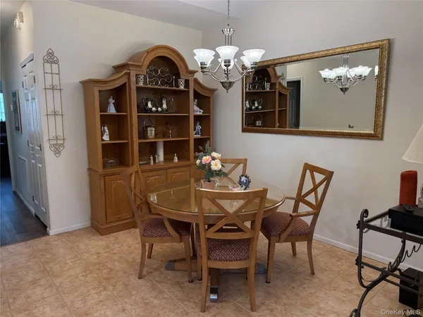 a view of a dining room with furniture and chandelier