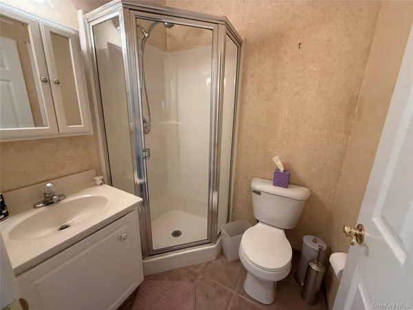 a bathroom with a toilet sink and a mirror