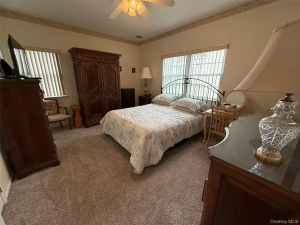 a bedroom with a bed and a television