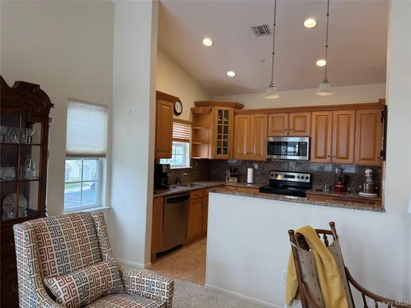 a kitchen with stainless steel appliances granite countertop a refrigerator and cabinets