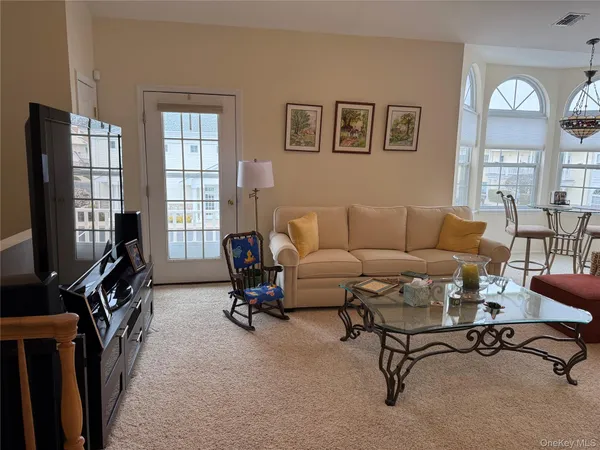 a living room with furniture a rug and a large window