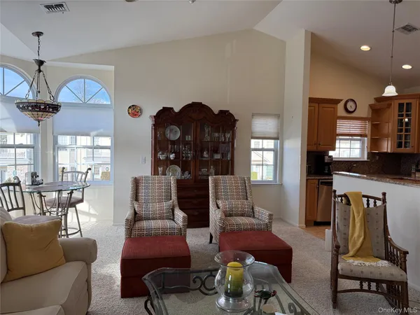 a living room with furniture a flat screen tv and a window