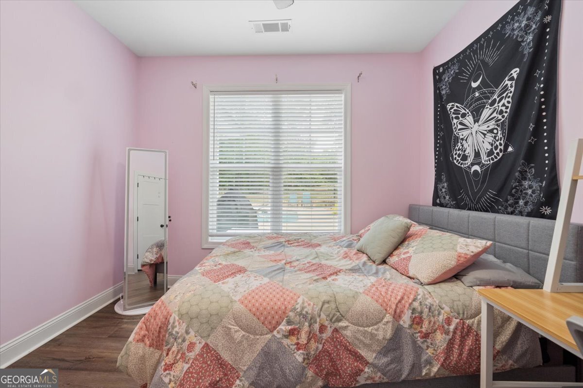 683 Teagle Road Forsyth, GA 31029 - Photo 22 of 50 a bedroom with a bed and a window
