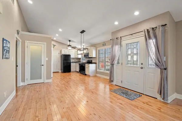 a kitchen with stainless steel appliances granite countertop a refrigerator a stove top oven a sink and dishwasher