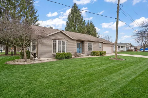 a view of a house with a yard and front view of a house