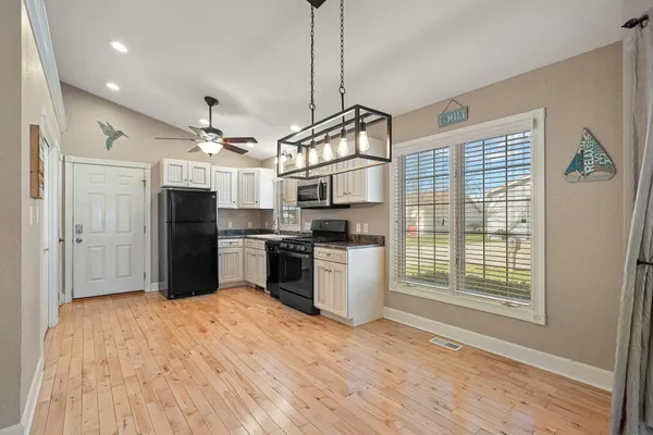 a view of a kitchen with wooden floor