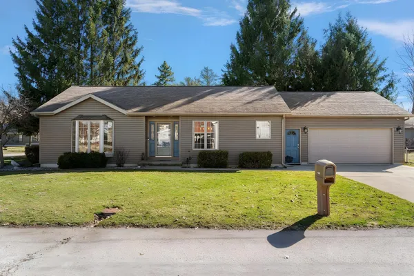 a front view of a house with a yard garage and outdoor seating