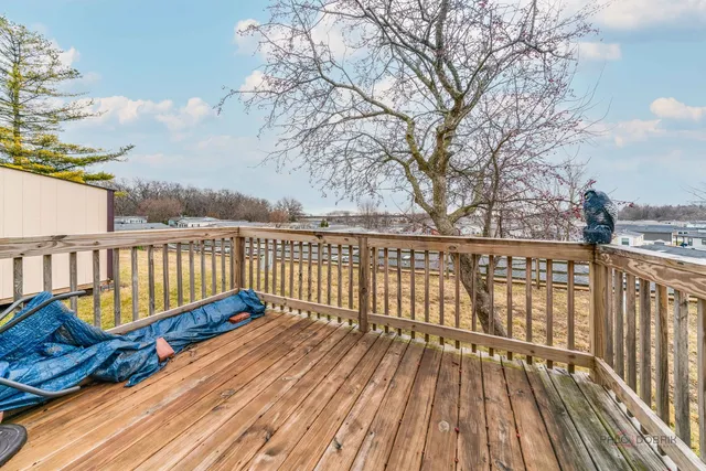 a balcony with wooden floor and fence