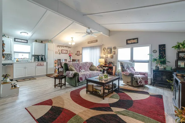 a living room with furniture wooden floor and a fireplace