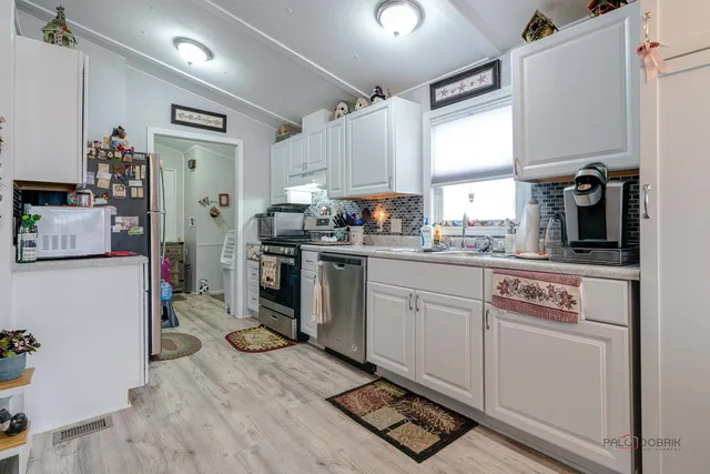 a kitchen with a sink appliances and cabinets