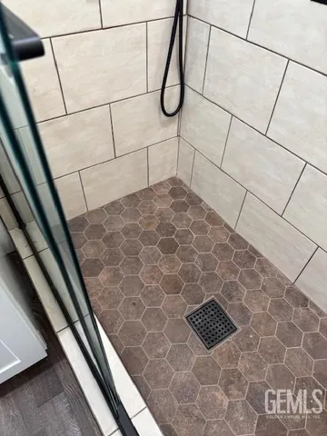 a bathroom with a glass door shower
