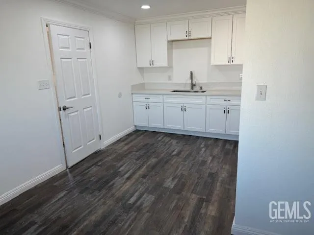 a view of a kitchen with sink and cabinets