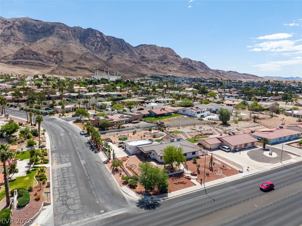 892 North Hollywood Boulevard Las Vegas, NV 89110 - Photo 69 of 81 An aerial view showcases a vibrant community nestled against a majestic mountain backdrop.