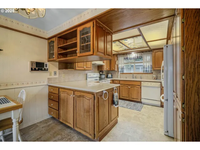 a kitchen with a sink cabinets and appliances