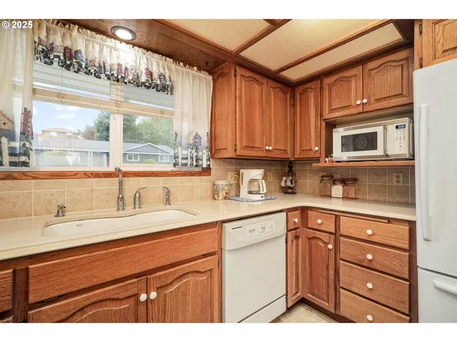 a kitchen with a sink cabinets and window