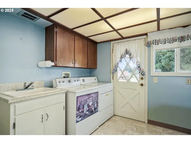 a utility room with closet dryer and washer