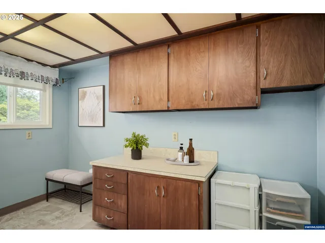 a kitchen with a sink cabinets and utility