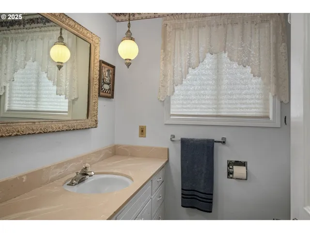 a bathroom with a sink vanity and a mirror