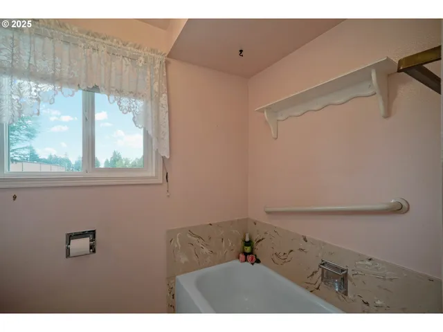 a bathroom with a window and a sink