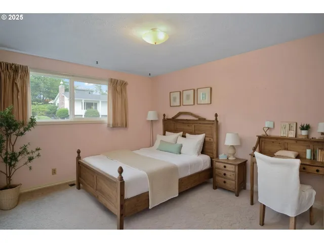 a bedroom with a bed and a potted plant